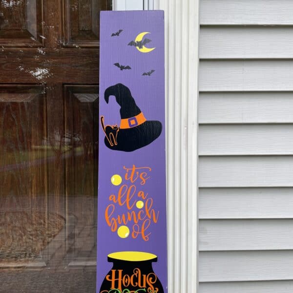 Greet trick or treaters with a Hocus Pocus porch sign. Bats flying, black bat, witches hat.