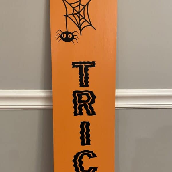 Trick or Treat spider hanging from web. Halloween indoor sign.