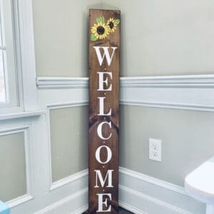 Great family and guests with a Welcome porch sign. Brown, yellow, with the word Welcome in white.