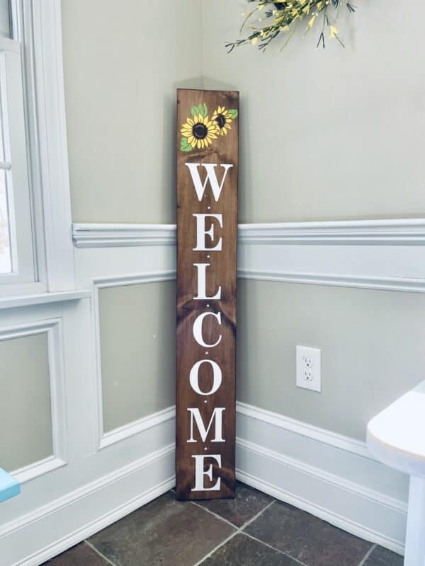 Great family and guests with a Welcome porch sign. Brown, yellow, with the word Welcome in white.