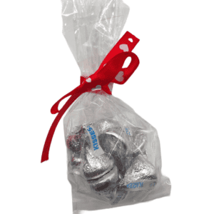 Candy Kisses for Love Mug wrapped in cellophane bag with a heart bow. A sweet treat for your loved one.