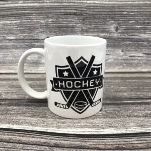 Hot chocolate hockey mug. White ceramic with black hockey design.