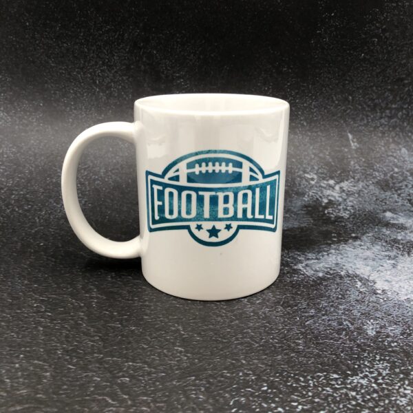 Football drinker gift. Coffee mug with football design. White ceramic with teal green design.