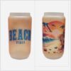 Beach tumbler, 16 oz. frosted glass shaped like beer can. Beach Vibes on front and beach scene on back in orange and blue.