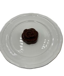 Milk chocolate rose-shaped chocolate covered Oreo on plate for Mother’s Day